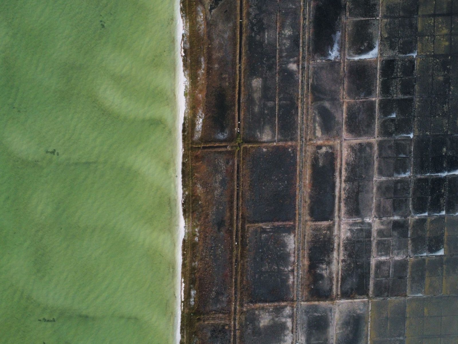 Coastal evaporation ponds along the shore