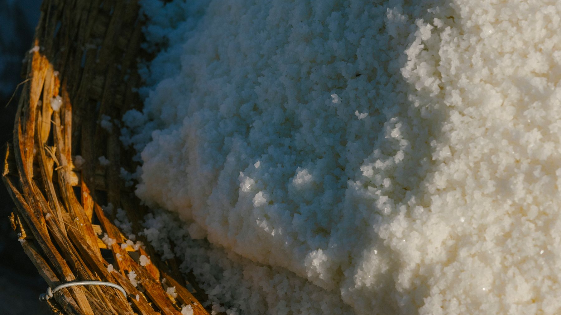 Coarse sea salt in a woven harvest basket