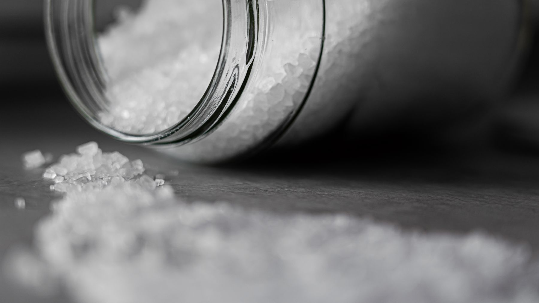 Sea salt poured from a gourmet glass jar