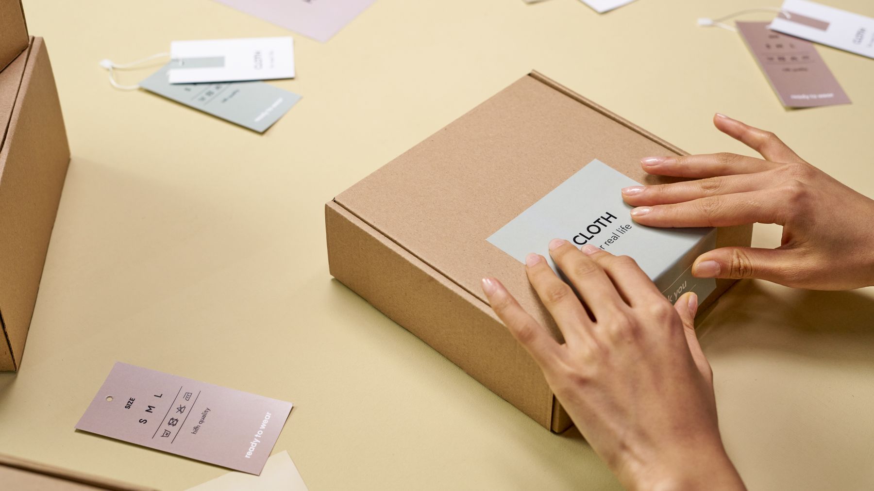 Hands packing cartons for a private-label order