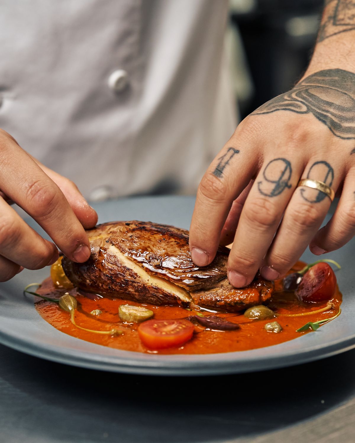 A chef plating a dish in a professional kitchen